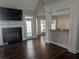 Cozy living room featuring a fireplace, hardwood floors, and natural light at 510 Pittman Mill Ct, Loganville, GA 30052
