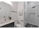 Modern bathroom with a glass-enclosed shower, a dark vanity, and geometric design at 1464 Ezra Church Nw Dr, Atlanta, GA 30314
