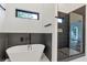 Modern bathroom featuring a soaking tub, sleek black fixtures, and a glass-enclosed shower at 1464 Ezra Church Nw Dr, Atlanta, GA 30314