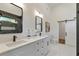 Bright bathroom with double sinks, quartz countertops, black fixtures, and modern lighting at 1464 Ezra Church Nw Dr, Atlanta, GA 30314