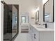 Elegant bathroom featuring double sinks, white cabinetry, and a glass-enclosed shower at 1464 Ezra Church Nw Dr, Atlanta, GA 30314