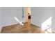 This bedroom features hardwood floors, white walls, and a view into the next room at 1464 Ezra Church Nw Dr, Atlanta, GA 30314