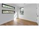 This bedroom features hardwood floors, modern windows, and white walls at 1464 Ezra Church Nw Dr, Atlanta, GA 30314