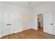 Bedroom with hardwood floors, double doors, and a view of the stairwell at 1464 Ezra Church Nw Dr, Atlanta, GA 30314