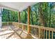 Large wooden deck with railing, overlooking a lush, green backyard at 1464 Ezra Church Nw Dr, Atlanta, GA 30314