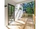 Wooden deck with sliding door, offering outdoor living space and backyard access at 1464 Ezra Church Nw Dr, Atlanta, GA 30314