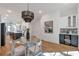 Open-concept dining area with a modern table, chairs, lighting, and convenient access to the kitchen at 1464 Ezra Church Nw Dr, Atlanta, GA 30314