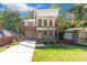 Two-story home boasts a spacious driveway, garage, and charming two-story balcony at 1464 Ezra Church Nw Dr, Atlanta, GA 30314