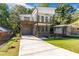 Modern two-story home features a gray and white exterior and a two-story balcony at 1464 Ezra Church Nw Dr, Atlanta, GA 30314