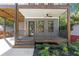 Inviting front porch features a ceiling fan, stylish railing, and well-manicured landscaping at 1464 Ezra Church Nw Dr, Atlanta, GA 30314