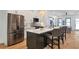 Modern kitchen with stainless steel refrigerator, center island with bar stools, and open to the living area at 1464 Ezra Church Nw Dr, Atlanta, GA 30314