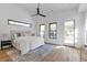 Bright main bedroom with neutral tones, a ceiling fan, and access to a balcony through glass doors at 1464 Ezra Church Nw Dr, Atlanta, GA 30314