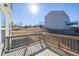 Wooden back deck offers a relaxing outdoor space with views of the neighboring homes and partially fenced backyard at 1530 Avalon Creek Rd, Sugar Hill, GA 30518