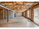 Unfinished basement featuring concrete floors, exposed ceiling, and natural light from the window at 1530 Avalon Creek Rd, Sugar Hill, GA 30518