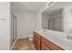 Bright bathroom features a double sink vanity with a large mirror and a walk-in shower at 1530 Avalon Creek Rd, Sugar Hill, GA 30518