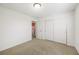 Carpeted bedroom showcasing a closet with sliding doors and neutral walls at 1530 Avalon Creek Rd, Sugar Hill, GA 30518