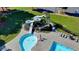 Water slide and pool with sunbathing areas and lounge chairs in the community at 1530 Avalon Creek Rd, Sugar Hill, GA 30518