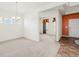 Inviting living and dining area with neutral tones, carpet flooring, and a glimpse of the front entry at 1530 Avalon Creek Rd, Sugar Hill, GA 30518