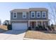 Charming two-story home with brick and siding exterior, showcasing a well-maintained front yard and attached two car garage at 1530 Avalon Creek Rd, Sugar Hill, GA 30518