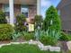Charming front yard with well-manicured landscaping, colorful flowers, and inviting porch furniture at 1530 Avalon Creek Rd, Sugar Hill, GA 30518