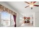 Bright living room with large windows, ceiling fan, and open access to the kitchen at 1530 Avalon Creek Rd, Sugar Hill, GA 30518