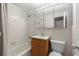 Tiled bathroom featuring a shower-tub combo, vanity, and a large mirror at 215 Piedmont Ne Ave # 1608, Atlanta, GA 30308