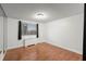 Bright bedroom featuring a large window with city views, a wall heater, and hardwood floors at 215 Piedmont Ne Ave # 1608, Atlanta, GA 30308