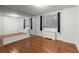 Bright bedroom featuring a large window with city views, a wall heater, hardwood floors and a mirrored wall at 215 Piedmont Ne Ave # 1608, Atlanta, GA 30308