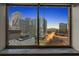 Skyline view framed by a window, showcasing city lights and architecture at 215 Piedmont Ne Ave # 1608, Atlanta, GA 30308