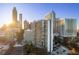 View of a high-rise building with a city skyline and bright sunshine at 215 Piedmont Ne Ave # 1608, Atlanta, GA 30308