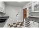 Well-equipped kitchen with a double sink, white cabinetry, and modern checkered floors at 215 Piedmont Ne Ave # 1608, Atlanta, GA 30308