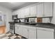 Well-equipped kitchen with stainless steel appliances, white cabinetry, and modern checkered floors at 215 Piedmont Ne Ave # 1608, Atlanta, GA 30308