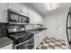 Well-equipped kitchen with stainless steel appliances, white cabinetry, and sleek countertops at 215 Piedmont Ne Ave # 1608, Atlanta, GA 30308