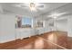 Bright living room with hardwood floors, a modern ceiling fan, and a mirrored wall that adds depth and style at 215 Piedmont Ne Ave # 1608, Atlanta, GA 30308