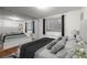 Comfortable main bedroom featuring city views, a large bed, and a mirrored accent wall at 215 Piedmont Ne Ave # 1608, Atlanta, GA 30308