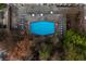 Aerial view of a community pool surrounded by trees and outdoor seating at 215 Piedmont Ne Ave # 1608, Atlanta, GA 30308