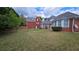 View of the large backyard featuring a lush lawn and a glimpse of the home's exterior at 2604 Harman Park Cir, Duluth, GA 30097