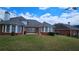 View of the backyard featuring a lush lawn, patio, and architectural details of the home at 2604 Harman Park Cir, Duluth, GA 30097