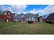 Large backyard showcasing the house's architectural details and a well-kept lawn at 2604 Harman Park Cir, Duluth, GA 30097