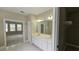 Bathroom featuring double sinks, a walk-in closet, and access to another room at 2604 Harman Park Cir, Duluth, GA 30097