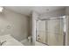 Well-lit bathroom featuring a shower with glass doors, a toilet, and a sink with a mirror at 2604 Harman Park Cir, Duluth, GA 30097