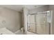 Bright bathroom featuring a shower with glass doors, a toilet, and a sink with vanity at 2604 Harman Park Cir, Duluth, GA 30097