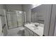 Bathroom with sink, toilet, and shower behind sliding glass door, plus support bars at 2604 Harman Park Cir, Duluth, GA 30097