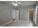Bedroom with neutral walls, carpet, ceiling fan, window, and an open doorway at 2604 Harman Park Cir, Duluth, GA 30097