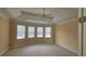 Spacious primary bedroom with a tray ceiling and ample natural light from many windows at 2604 Harman Park Cir, Duluth, GA 30097