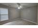 Neutral bedroom featuring a ceiling fan, and a window with natural light at 2604 Harman Park Cir, Duluth, GA 30097