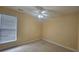 Bedroom with neutral carpet, baseboard trim, and a single window at 2604 Harman Park Cir, Duluth, GA 30097