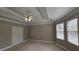 Bright bedroom with a tray ceiling, ceiling fan, and large windows at 2604 Harman Park Cir, Duluth, GA 30097