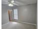Bedroom with neutral walls, carpet flooring, window with blinds, and an open doorway at 2604 Harman Park Cir, Duluth, GA 30097