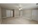 Bright bedroom with plush carpet, a ceiling fan, and multiple doors for easy access at 2604 Harman Park Cir, Duluth, GA 30097